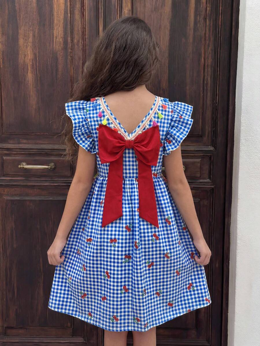 Tween girls blue short smock dress featuring flounce short sleeves, high waist flared hem, round neck, and front bow detail.