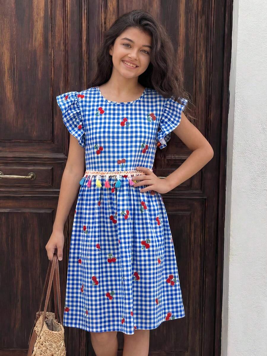 Tween girls blue short smock dress featuring flounce short sleeves, high waist flared hem, round neck, and front bow detail.