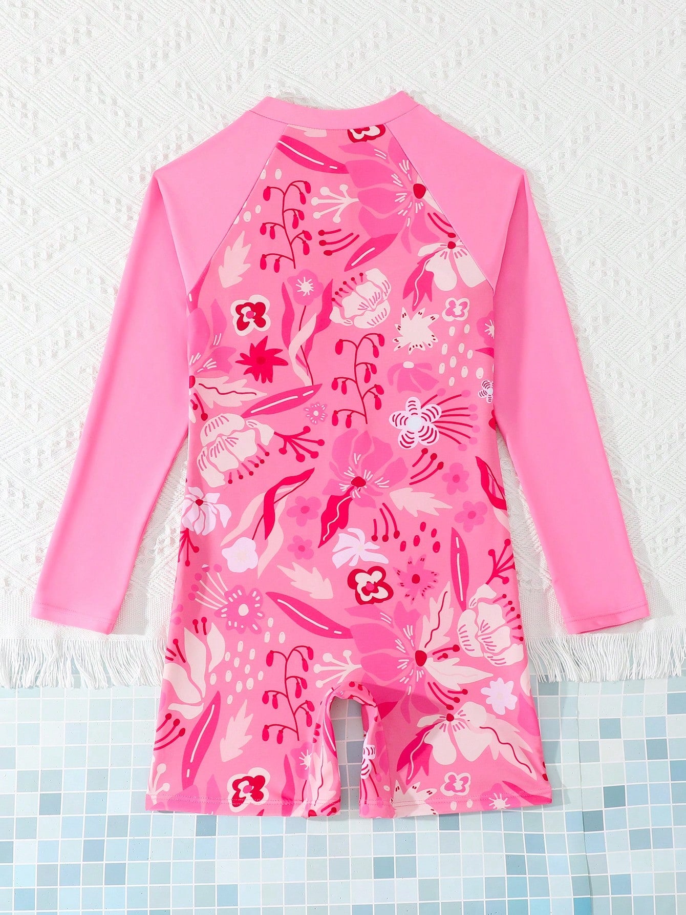 Tween girls one-piece swimsuit featuring a high neck, long sleeves, and shorts bottom, with a back zipper and strawberry plaid digital print on stretch knit fabric. Designed for swimming, vacation, and summer wear.
