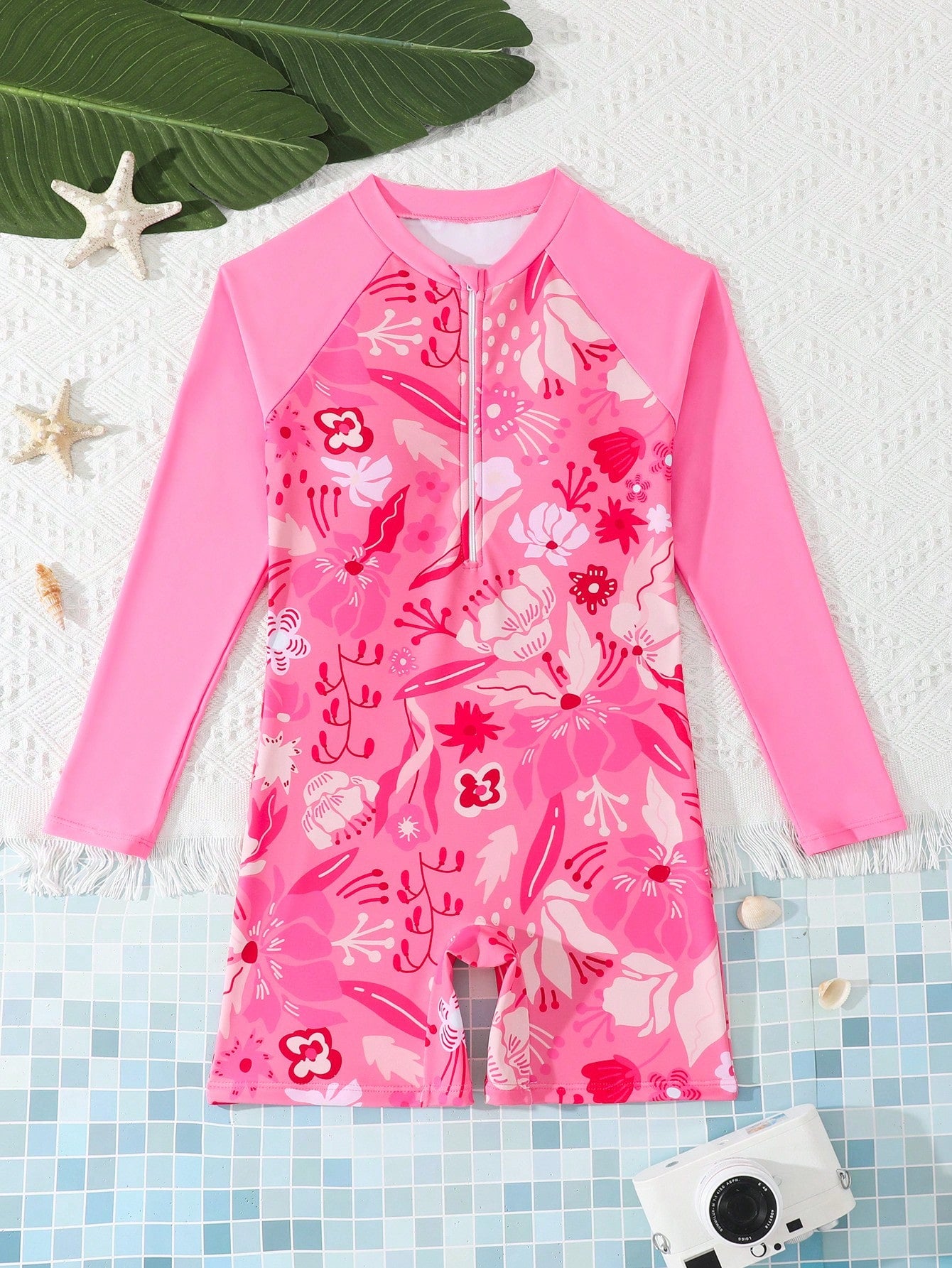 Tween girls one-piece swimsuit featuring a high neck, long sleeves, and shorts bottom, with a back zipper and strawberry plaid digital print on stretch knit fabric. Designed for swimming, vacation, and summer wear.