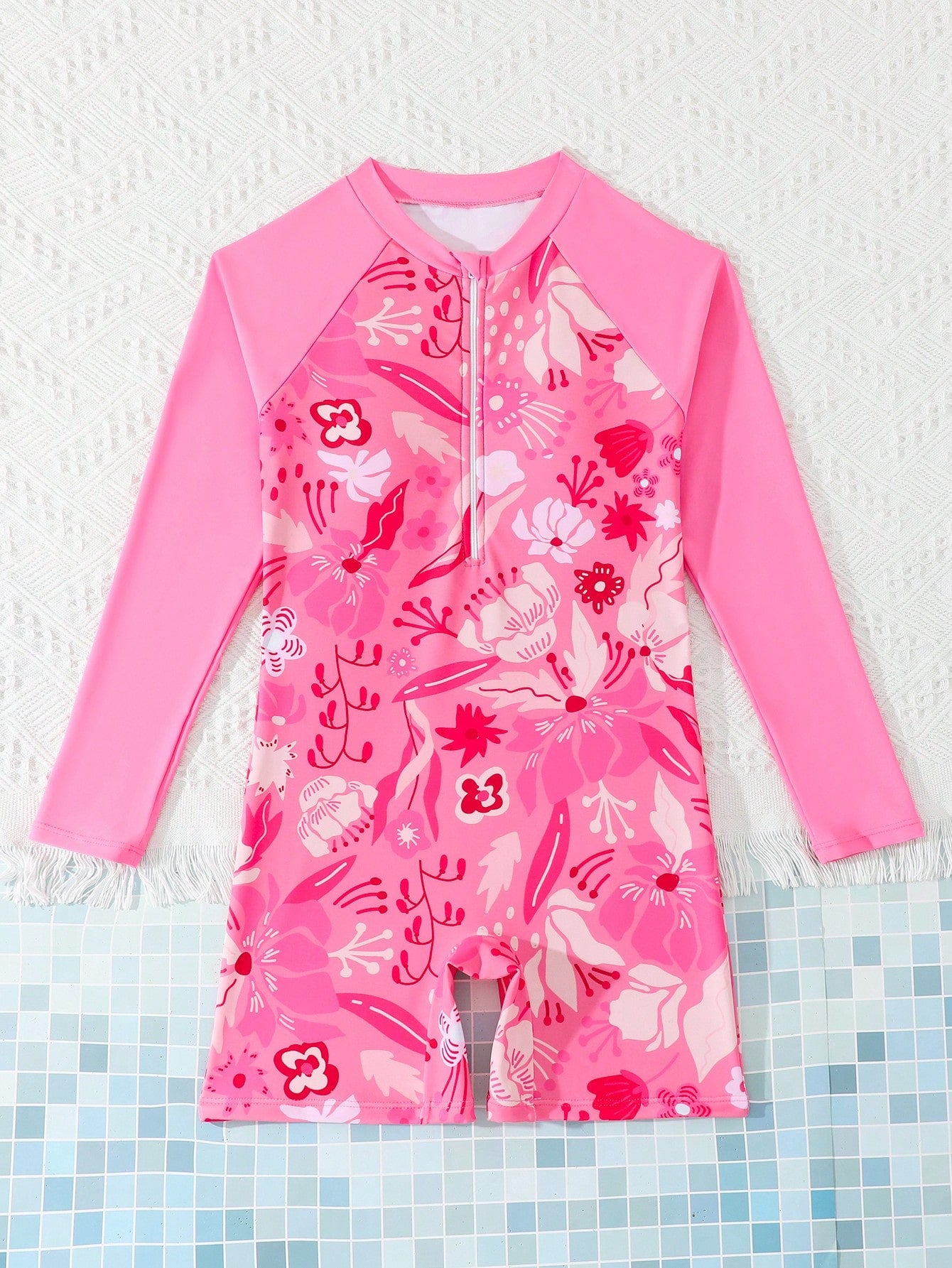 Tween girls one-piece swimsuit featuring a high neck, long sleeves, and shorts bottom, with a back zipper and strawberry plaid digital print on stretch knit fabric. Designed for swimming, vacation, and summer wear.