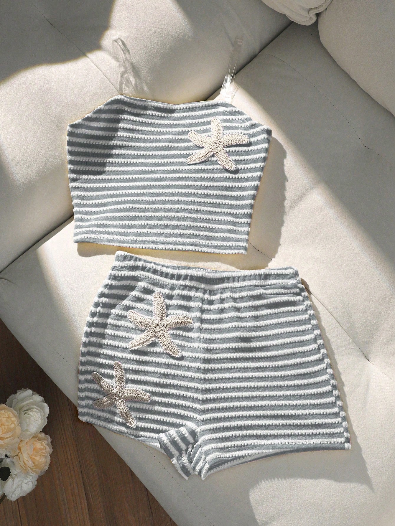 Tween girls black and white striped two-piece set featuring a spaghetti strap micro crop tank top with lettuce trim and ruffle hem paired with matching slim fit shorts.