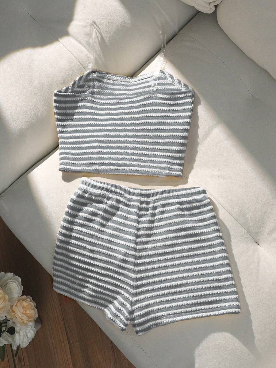 Tween girls black and white striped two-piece set featuring a spaghetti strap micro crop tank top with lettuce trim and ruffle hem paired with matching slim fit shorts.