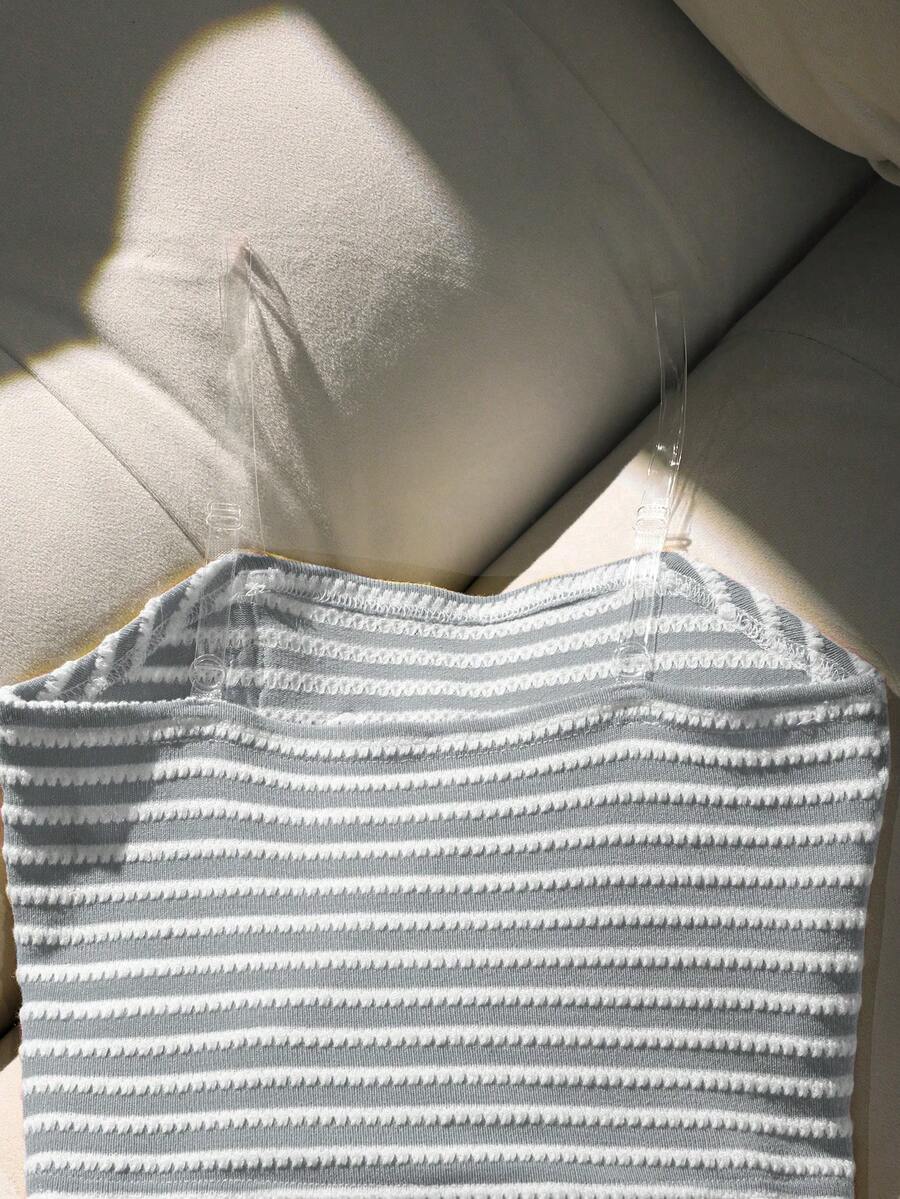 Tween girls black and white striped two-piece set featuring a spaghetti strap micro crop tank top with lettuce trim and ruffle hem paired with matching slim fit shorts.