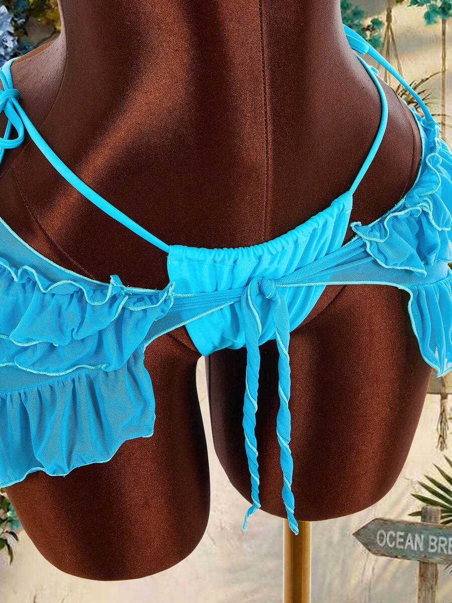 Women's 3-piece blue bikini swimwear set featuring a crop top with 3D rose accents, tie back detail, spaghetti straps, and tie-side bottoms.