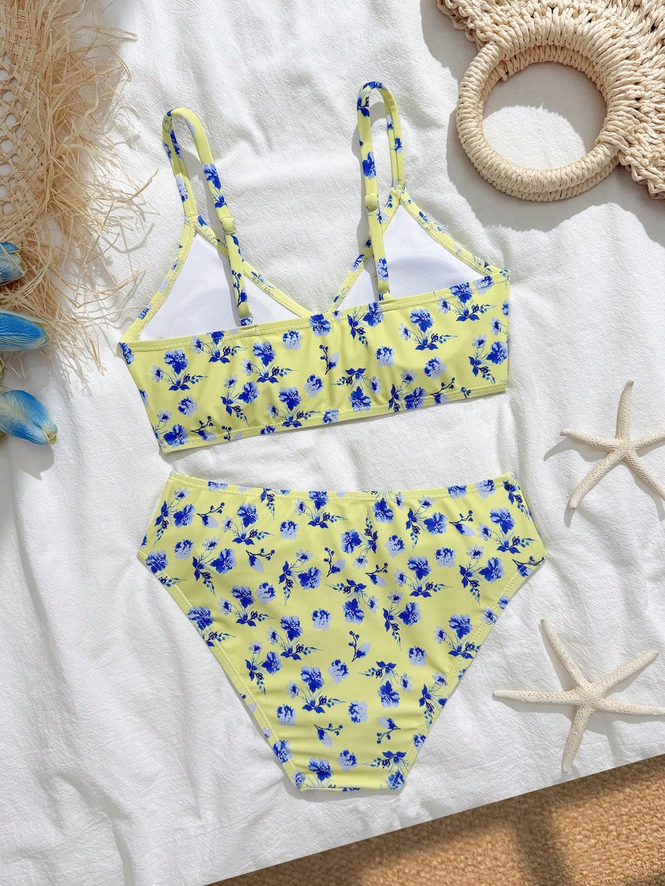 Tween girls 2-piece ditsy floral bikini set featuring a spaghetti strap top with center string detail and matching bottoms with side strings, designed for swimming, vacation, and summer wear.