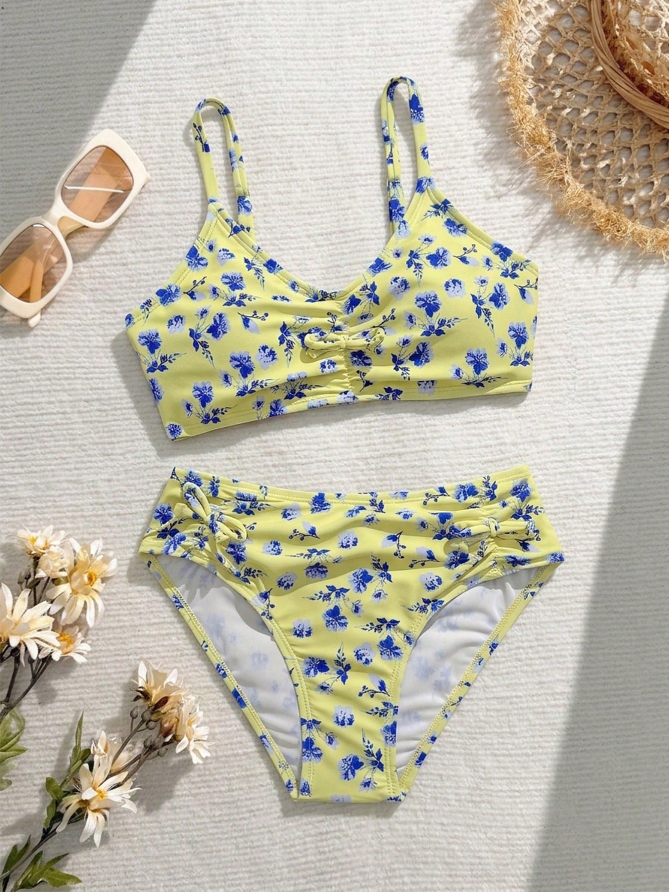 Tween girls 2-piece ditsy floral bikini set featuring a spaghetti strap top with center string detail and matching bottoms with side strings, designed for swimming, vacation, and summer wear.