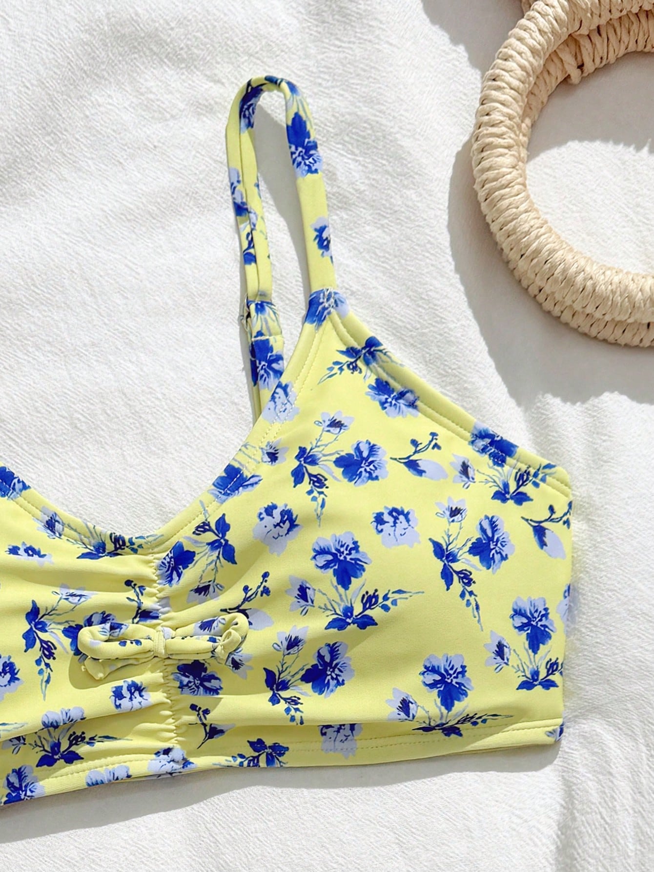 Tween girls 2-piece ditsy floral bikini set featuring a spaghetti strap top with center string detail and matching bottoms with side strings, designed for swimming, vacation, and summer wear.