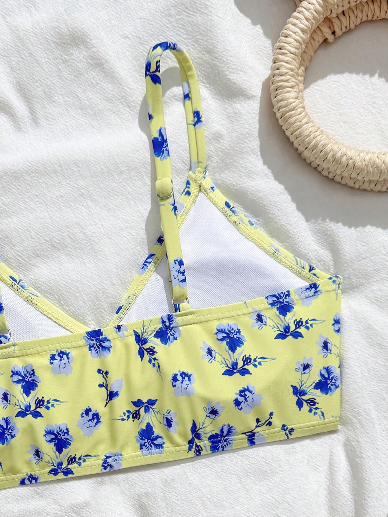 Tween girls 2-piece ditsy floral bikini set featuring a spaghetti strap top with center string detail and matching bottoms with side strings, designed for swimming, vacation, and summer wear.