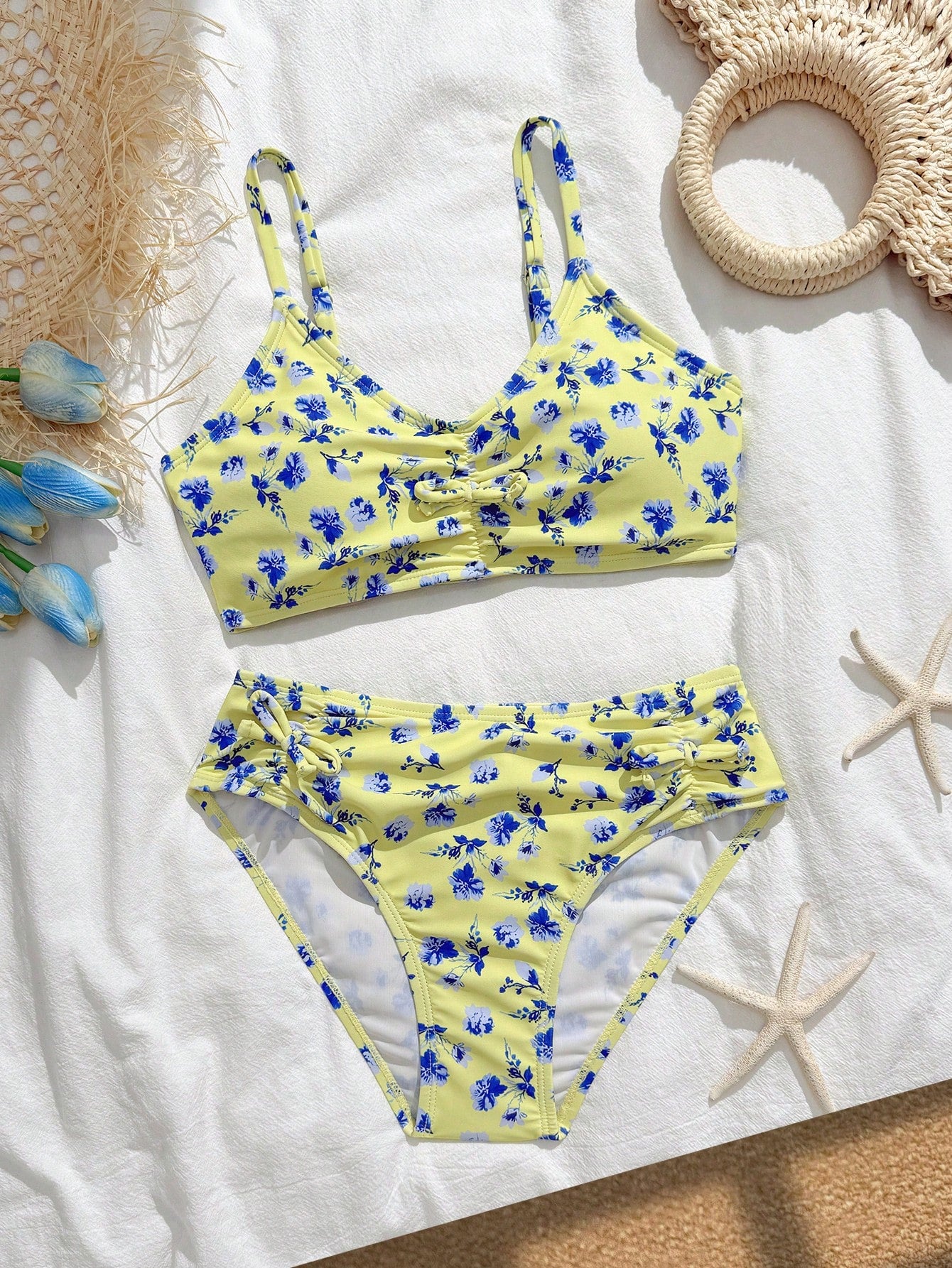 Tween girls 2-piece ditsy floral bikini set featuring a spaghetti strap top with center string detail and matching bottoms with side strings, designed for swimming, vacation, and summer wear.