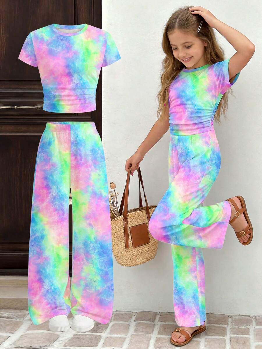 Tween girl 2-piece summer set featuring a white printed short-sleeve T-shirt and black and white striped long pants.