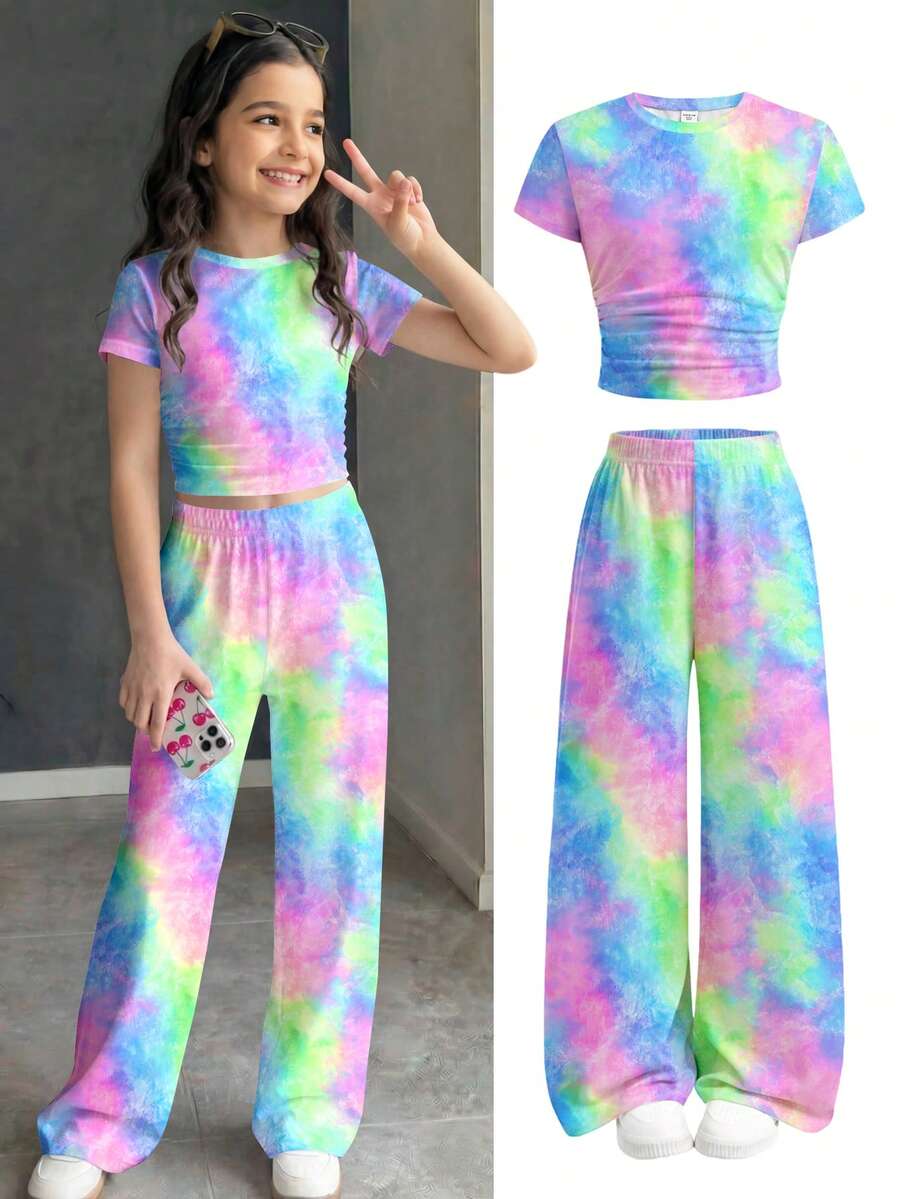 Tween girl 2-piece summer set featuring a white printed short-sleeve T-shirt and black and white striped long pants.