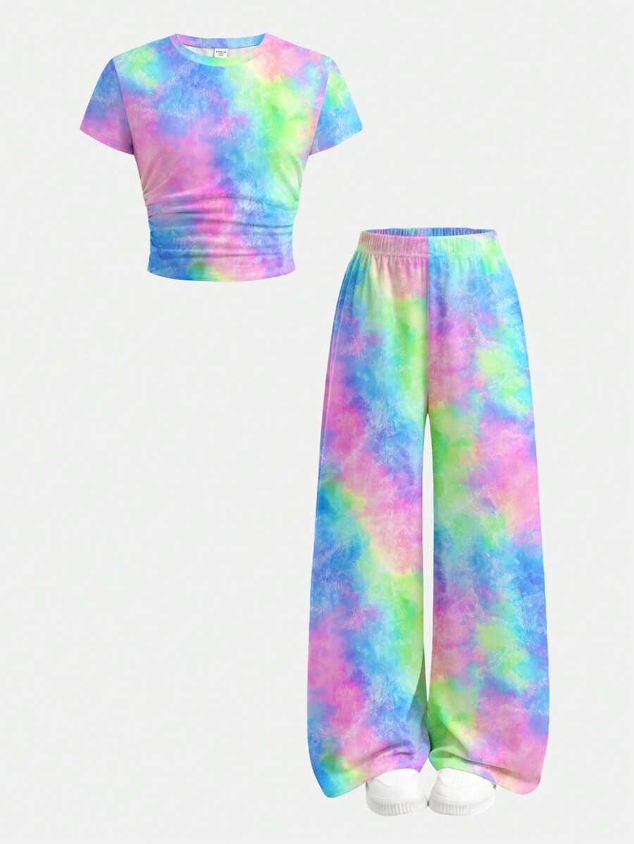 Tween girl 2-piece summer set featuring a white printed short-sleeve T-shirt and black and white striped long pants.