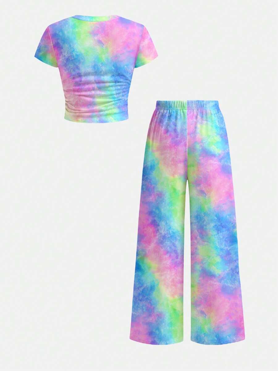 Tween girl 2-piece summer set featuring a white printed short-sleeve T-shirt and black and white striped long pants.