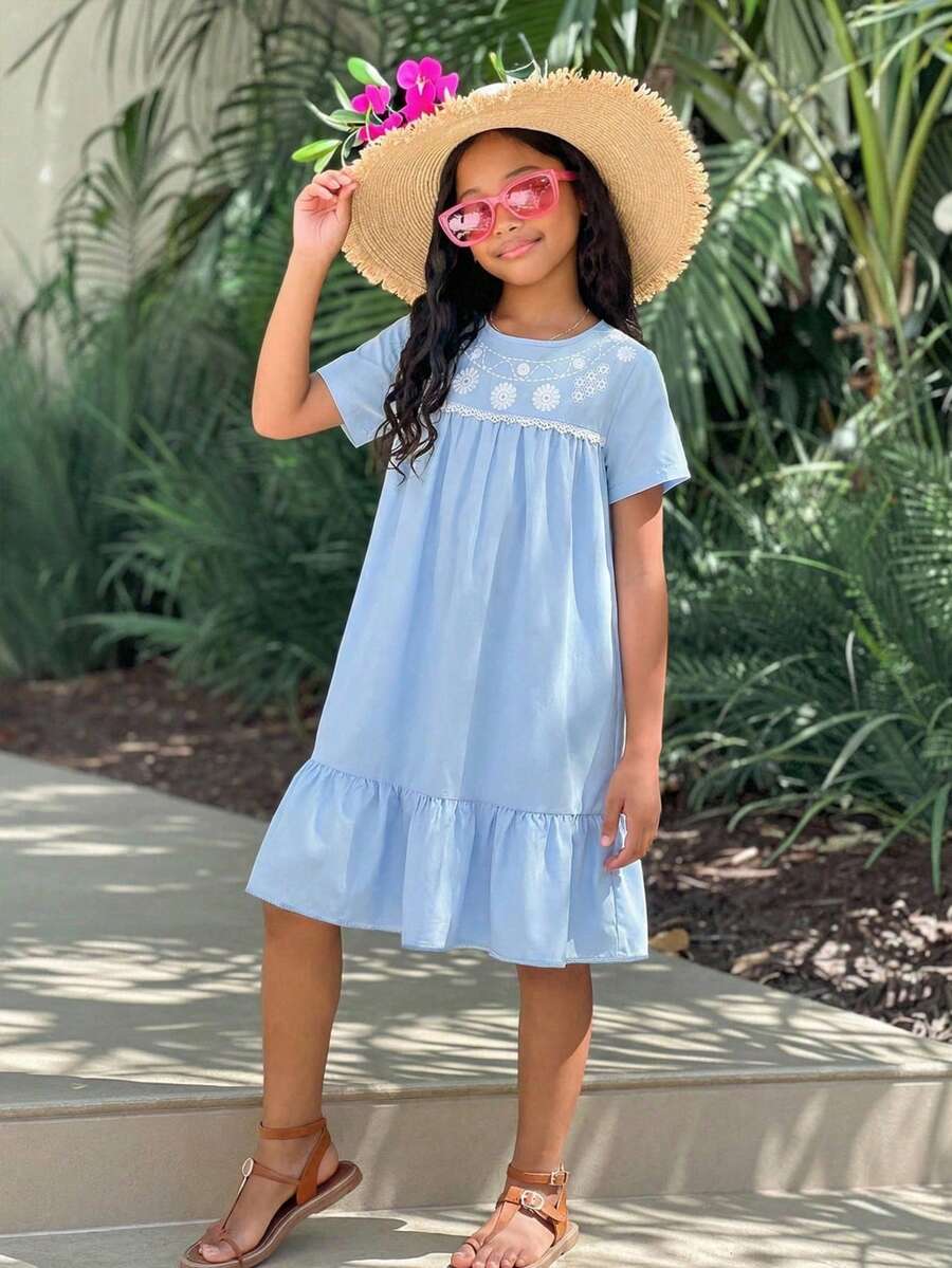 Tween girl wearing an Army Green textured short sleeve smock midi dress with round neck and ruffle flounce hem.