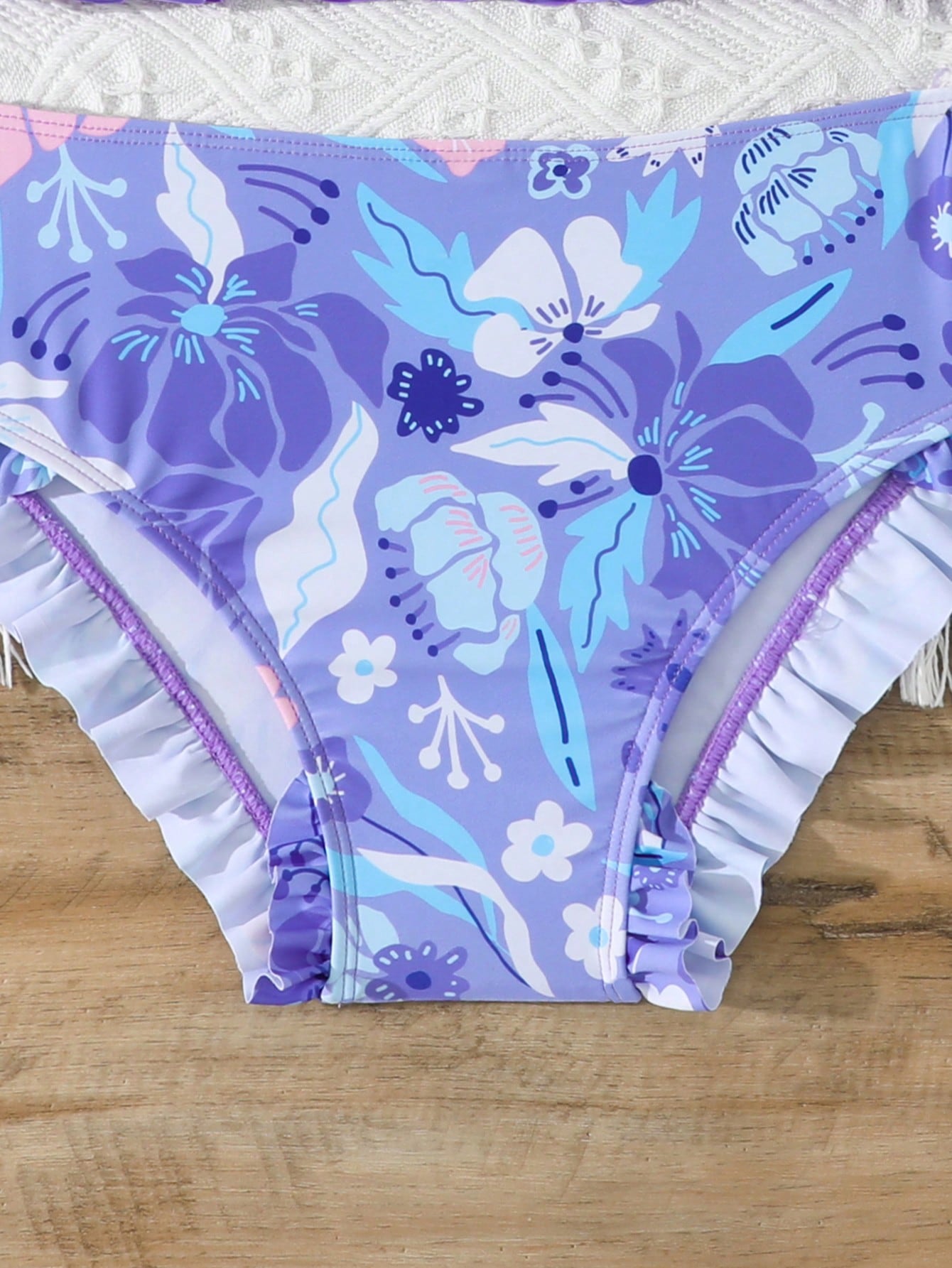 Tween girls solid color 2-piece bikini swimwear set with ruffle detail, strap neckline, wireless bikini top, and triangle mid-waist bikini bottoms; textured pattern with lined bottoms and high-stretch fabric, suitable for summer vacation.