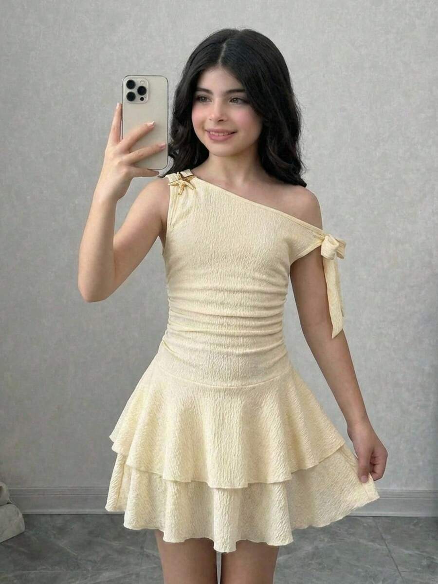 Apricot tiered asymmetrical ruffle dress for tween girls featuring short sleeves, layered hem, and slim fit A-line silhouette.
