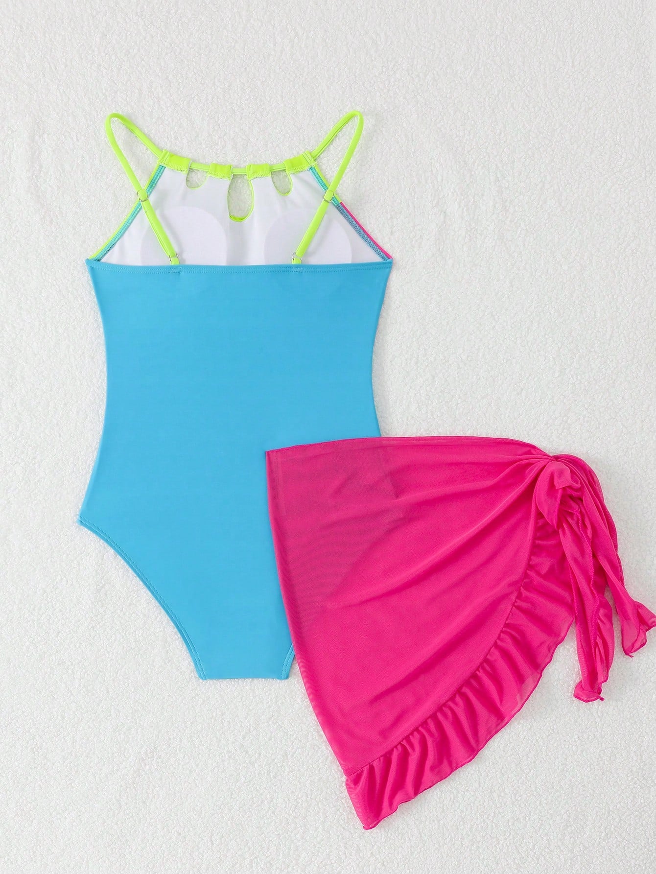 Girls black and white one-piece swimsuit set with cut-out detail, spaghetti straps, sleeveless fitted design, and matching skirt bottom for vacation swimwear.