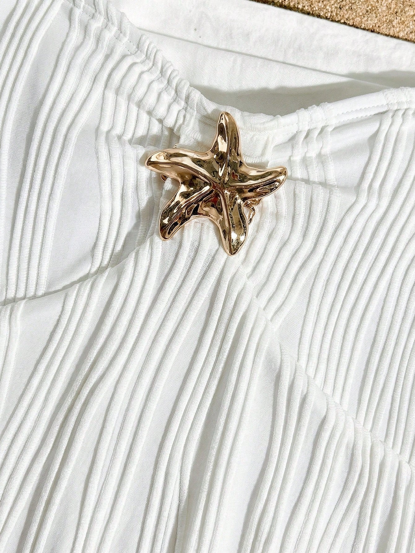 Apricot one-piece swimsuit for tween girls with a halter neckline, ruffle trim, textured knit fabric, fitted shape, and starfish metal decor.