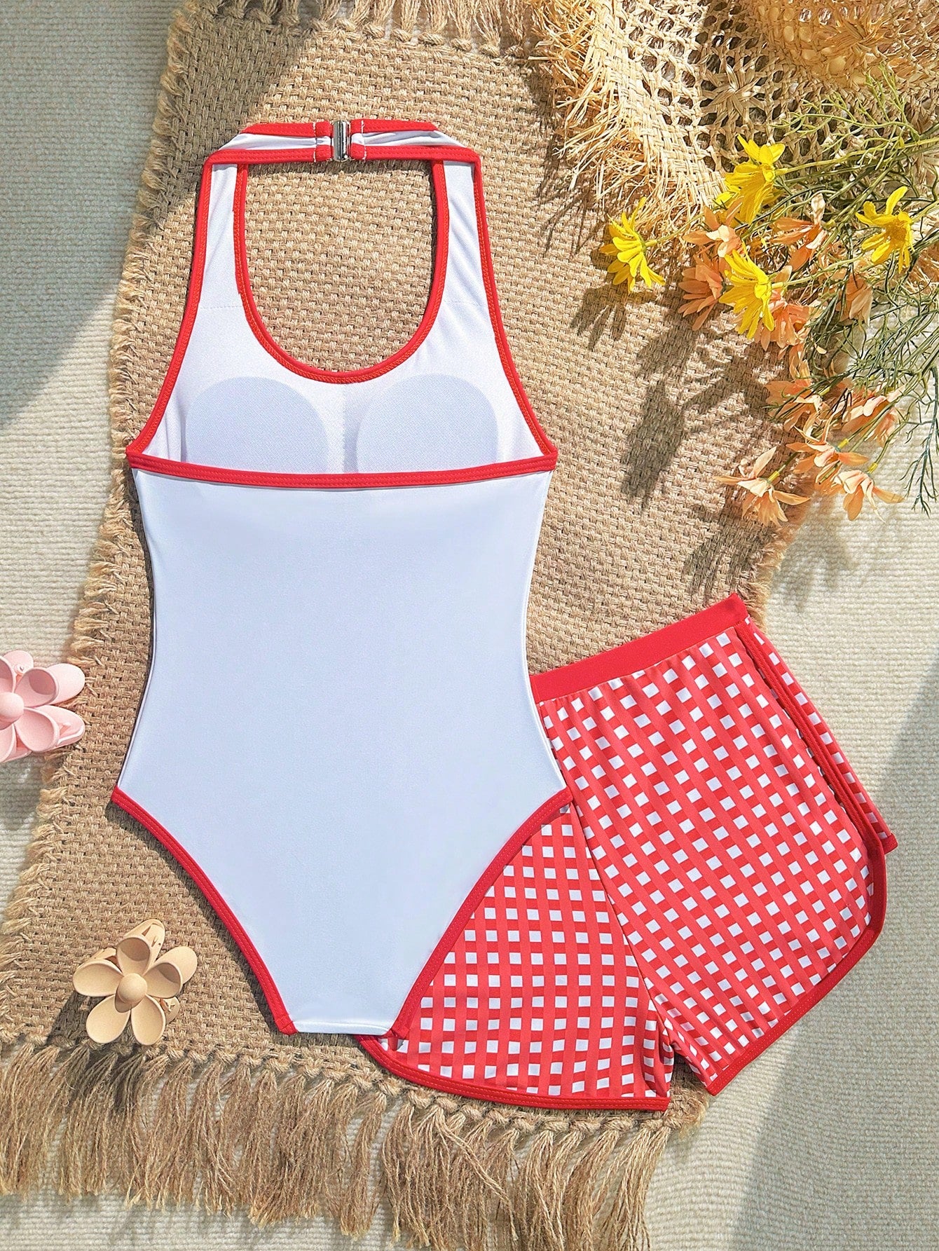 Girls 2-piece swimwear set featuring a butterfly print halter swimsuit top with contrast piping and separate mid-waist shorts; sleeveless, high-stretch, wireless design for beach and vacation wear.