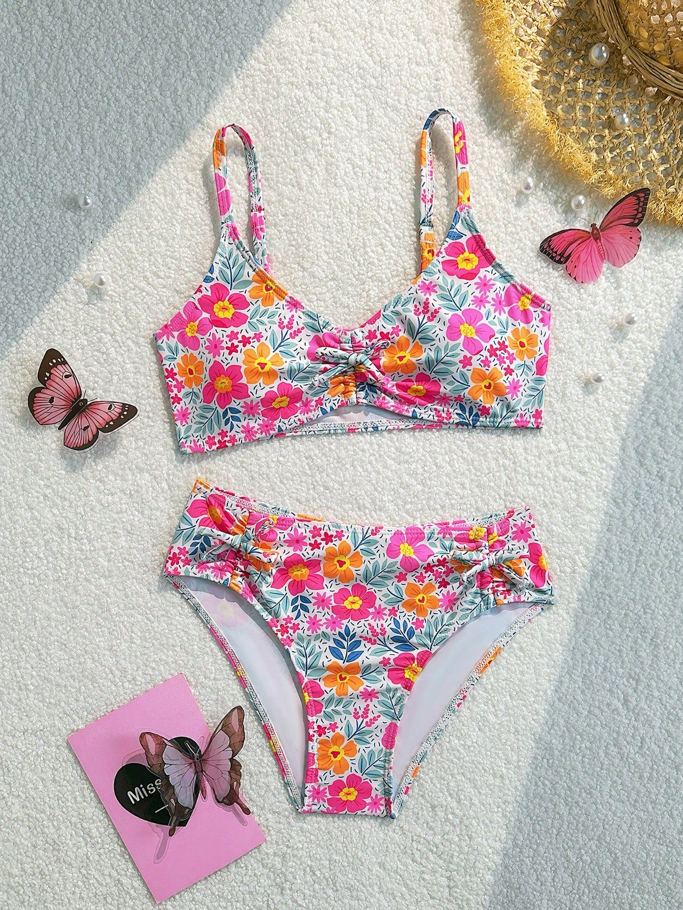 Tween girls 2-piece ditsy floral bikini set featuring a spaghetti strap top with center string detail and matching bottoms with side strings, designed for swimming, vacation, and summer wear.