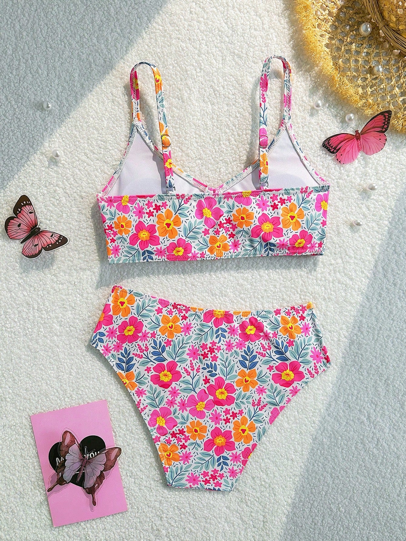 Tween girls 2-piece ditsy floral bikini set featuring a spaghetti strap top with center string detail and matching bottoms with side strings, designed for swimming, vacation, and summer wear.