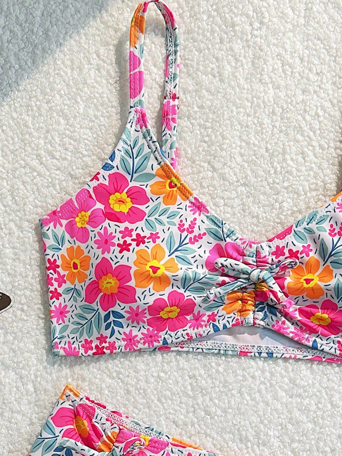 Tween girls 2-piece ditsy floral bikini set featuring a spaghetti strap top with center string detail and matching bottoms with side strings, designed for swimming, vacation, and summer wear.