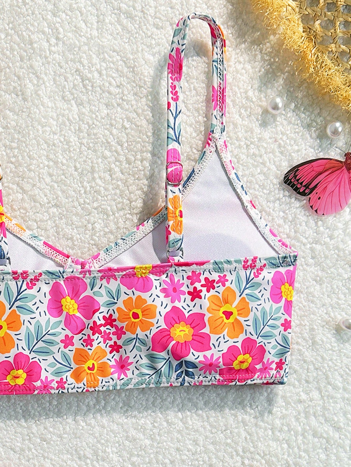 Tween girls 2-piece ditsy floral bikini set featuring a spaghetti strap top with center string detail and matching bottoms with side strings, designed for swimming, vacation, and summer wear.