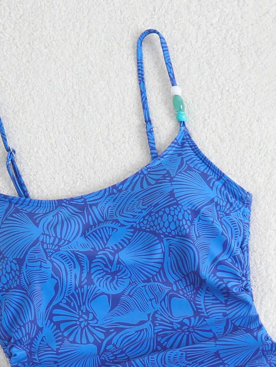 Women's blue backless one-piece swimsuit featuring spaghetti straps, wireless bra with removable padding, and drawstring details.