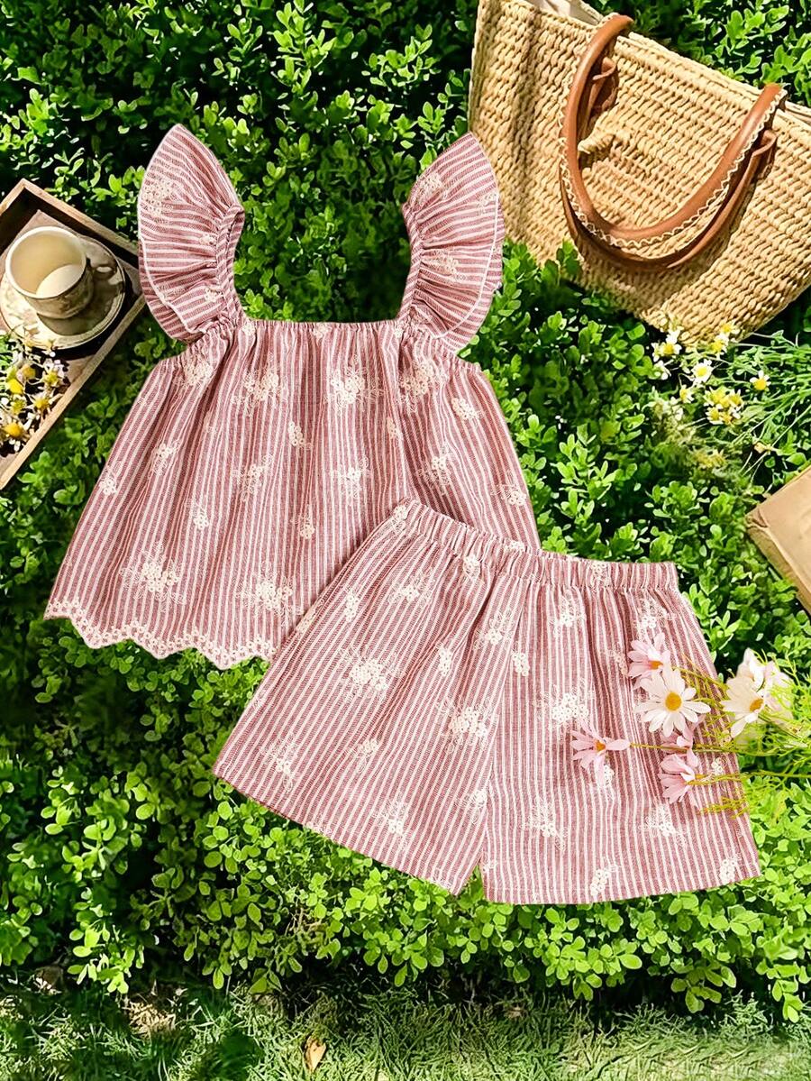 Tween girl wearing a blue and white striped sleeveless top featuring embroidery details and ruffle trim with matching shorts.