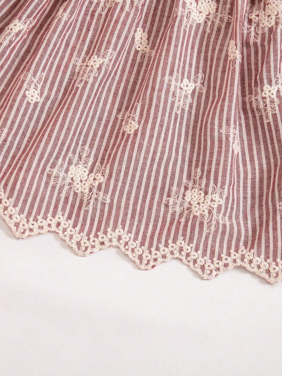 Tween girl wearing a blue and white striped sleeveless top featuring embroidery details and ruffle trim with matching shorts.