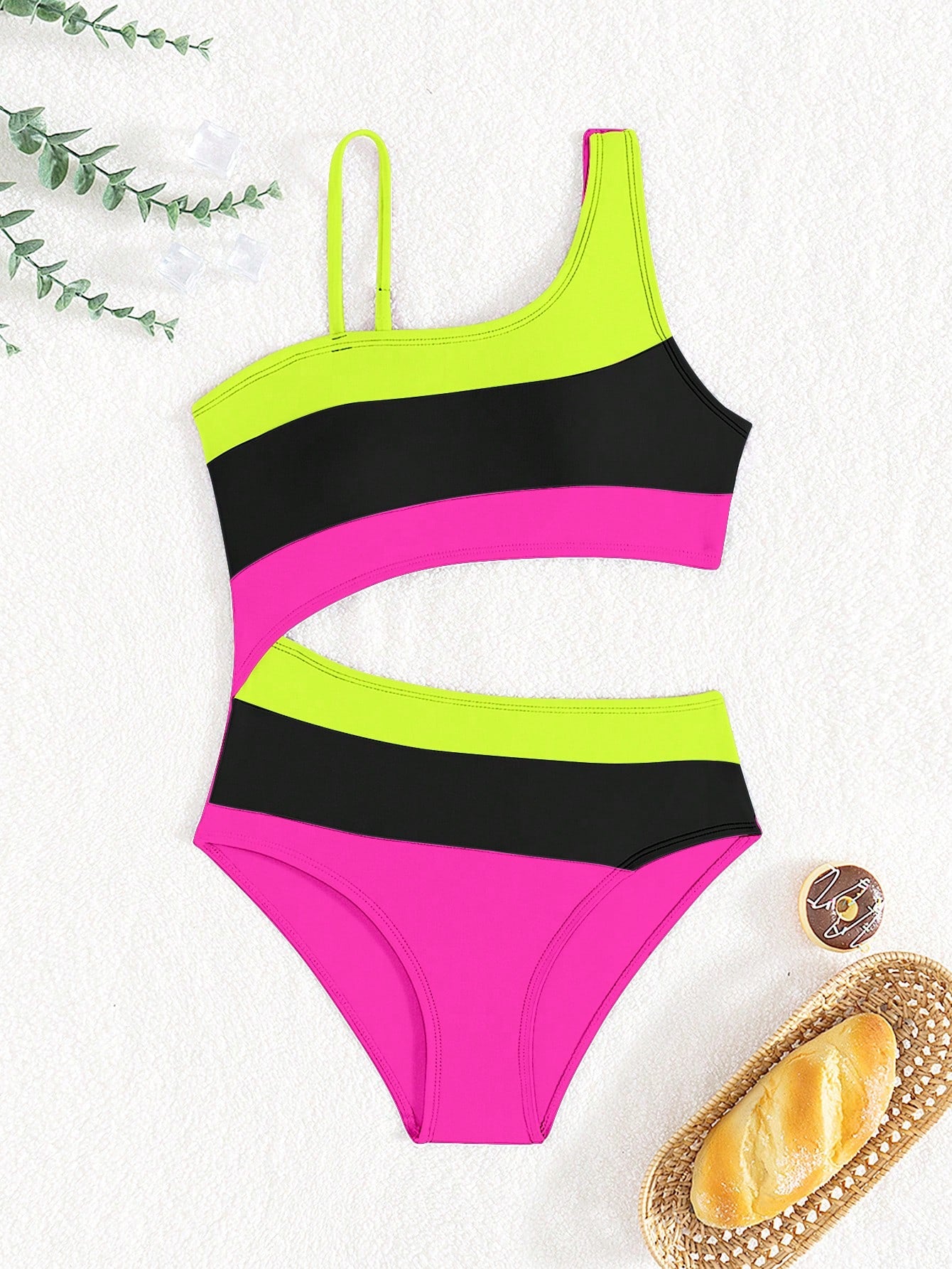 Black one-piece swimsuit for tween girls with cut out detail, spaghetti straps, high waist bottom, wireless bra, and fitted vacation swimwear style.