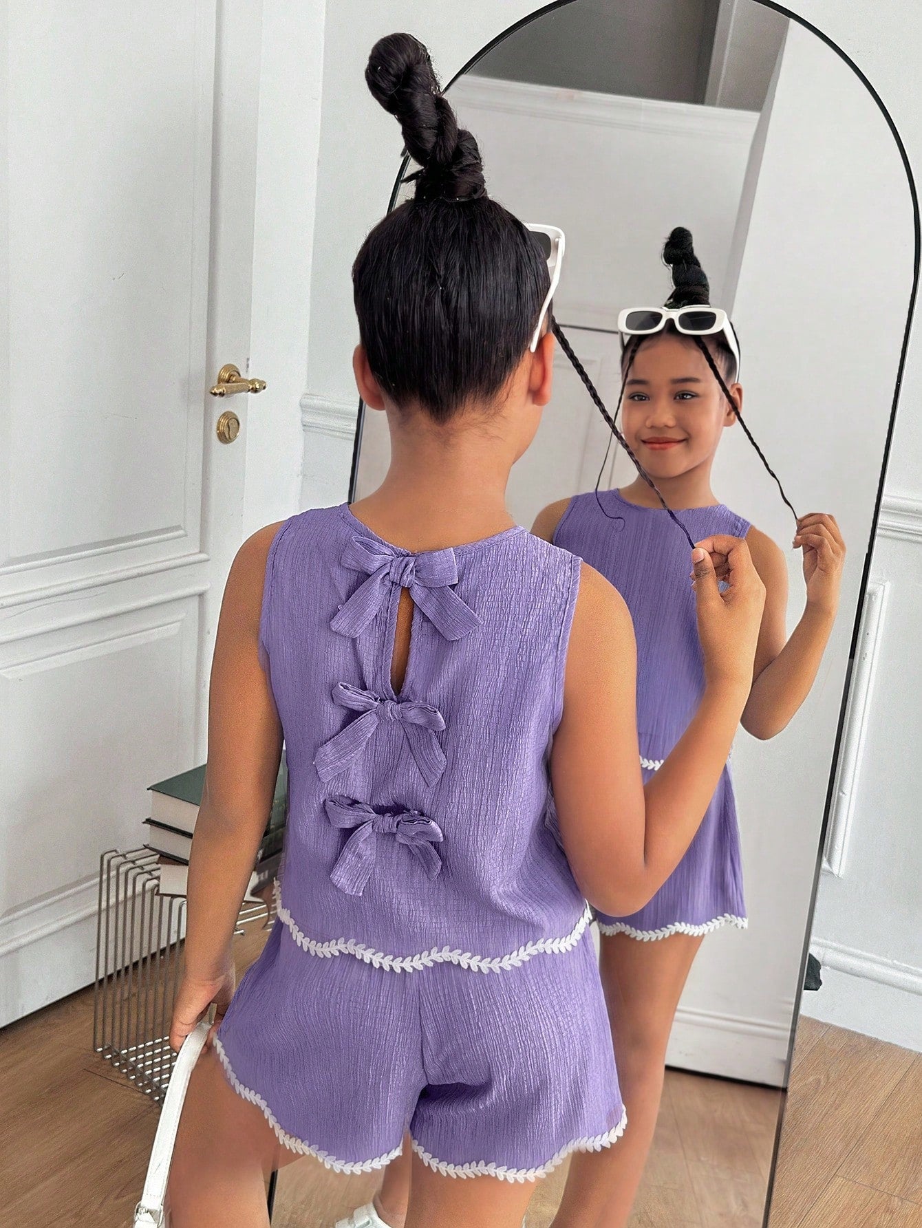 Tween girls casual blue tank top featuring round neck, textured fabric, and bow detail paired with matching shorts set.