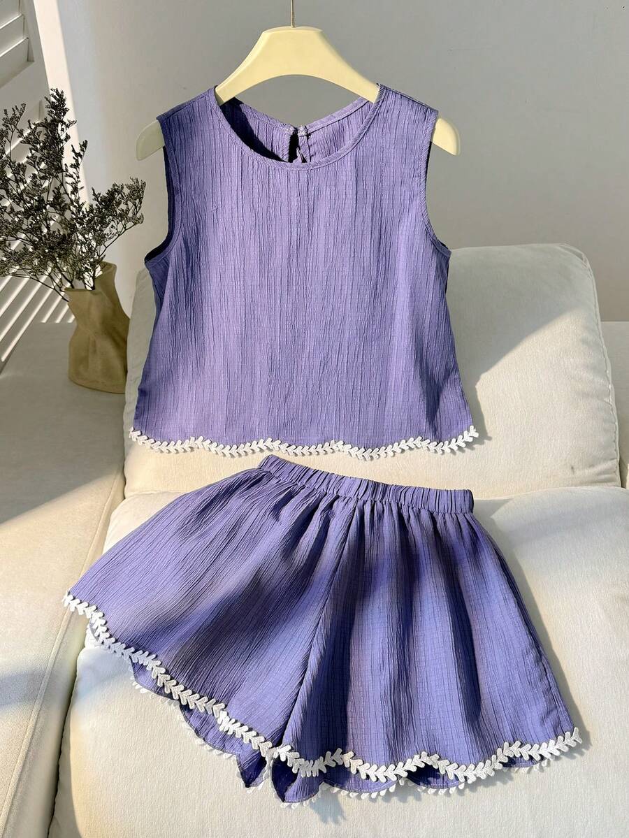 Tween girls casual blue tank top featuring round neck, textured fabric, and bow detail paired with matching shorts set.