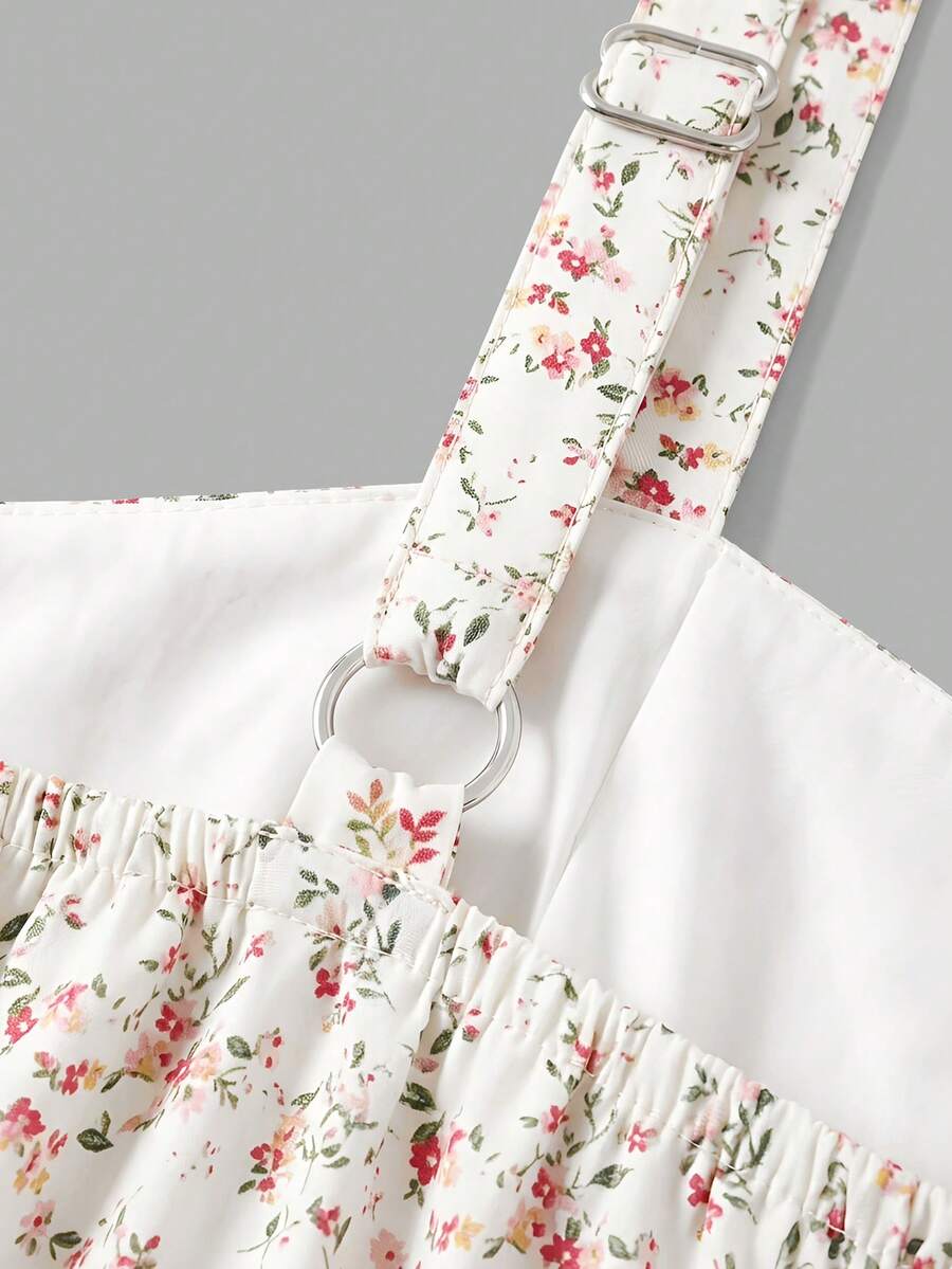 Tween girls blue ditsy floral sleeveless long dress with spaghetti straps, ruched bust, high waist, and tiered layered hem.