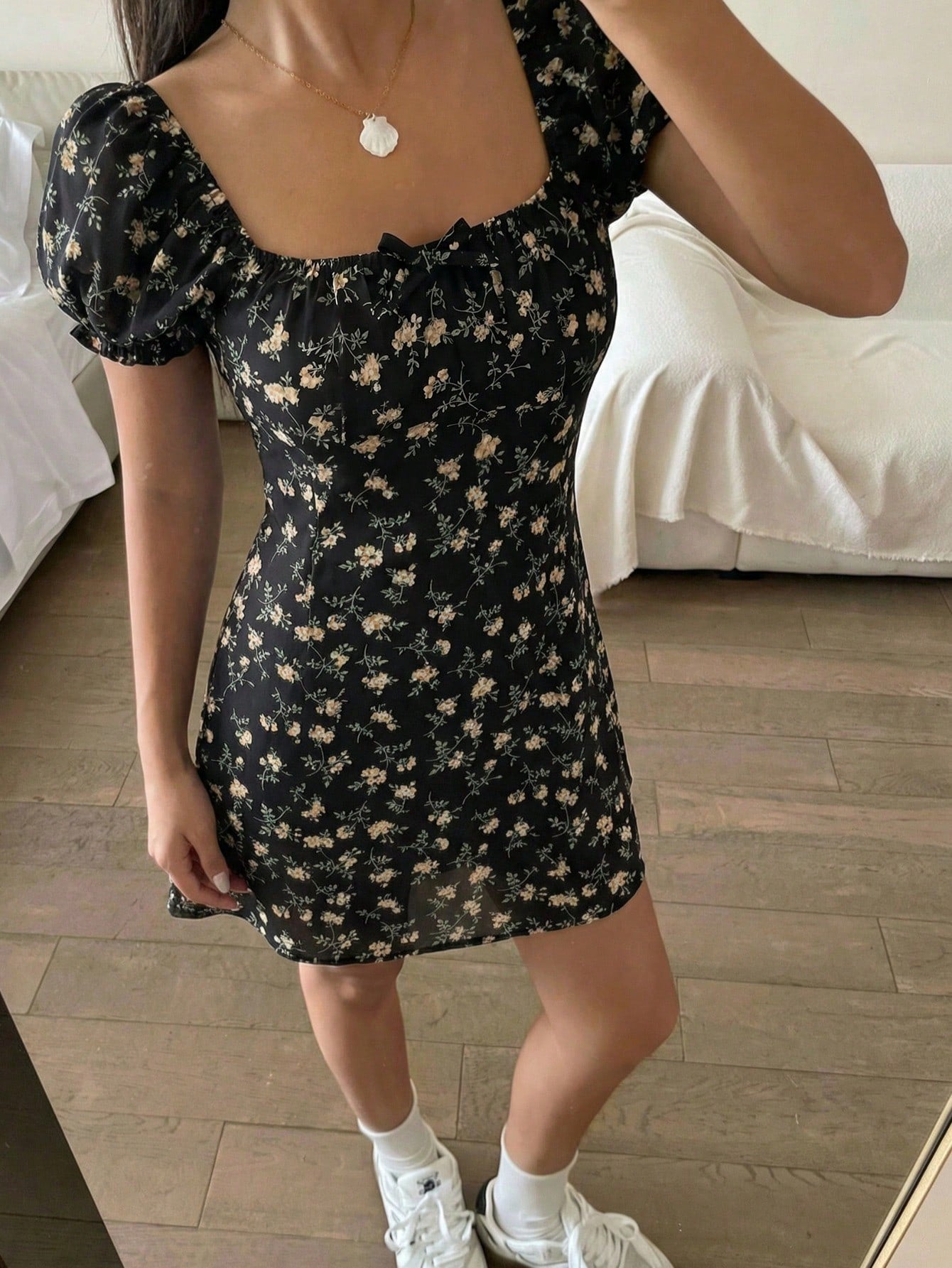 Black floral all-over print midi dress for tween girls featuring puff half sleeves, spaghetti strap neckline, and an A-line silhouette.