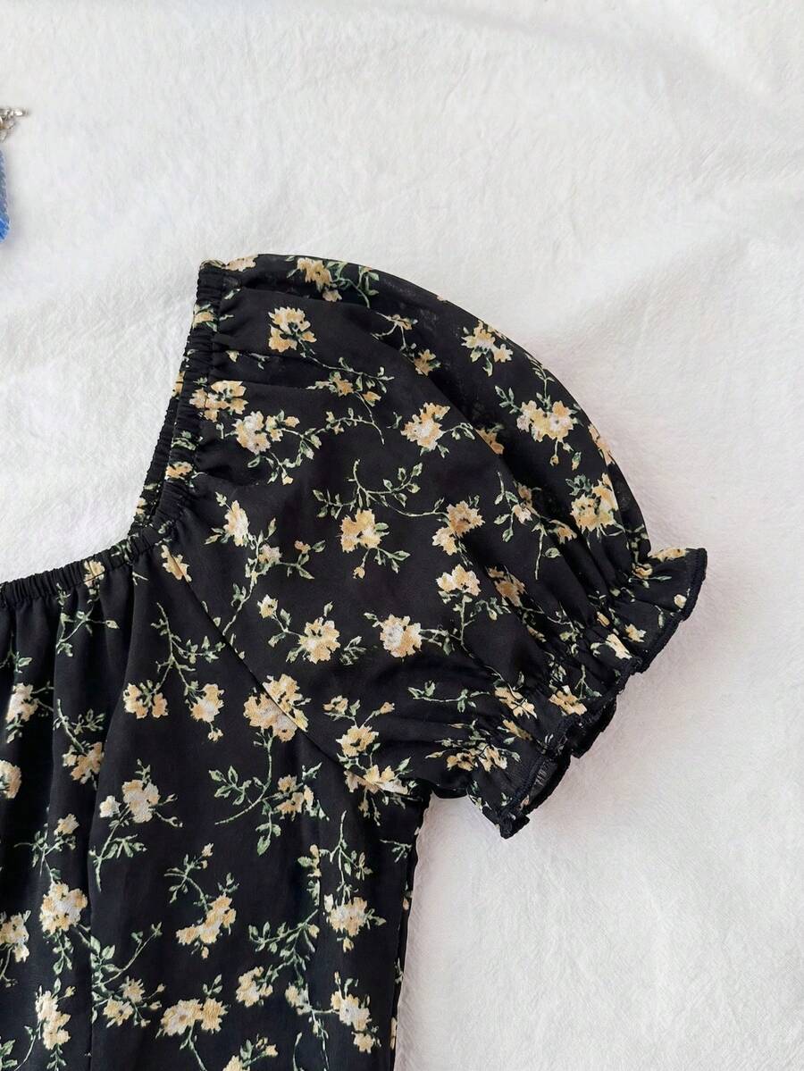 Black floral all-over print midi dress for tween girls featuring puff half sleeves, spaghetti strap neckline, and an A-line silhouette.