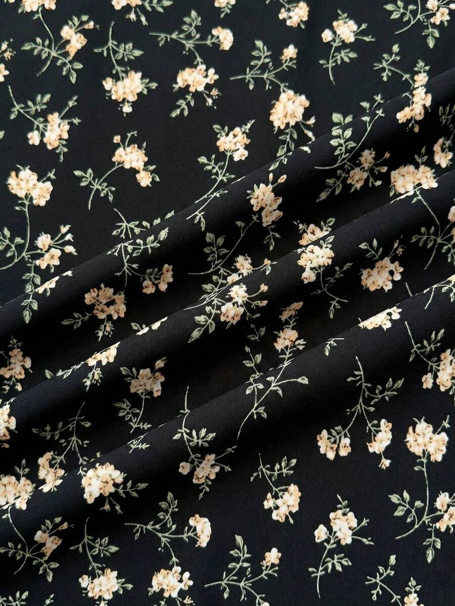 Black floral all-over print midi dress for tween girls featuring puff half sleeves, spaghetti strap neckline, and an A-line silhouette.