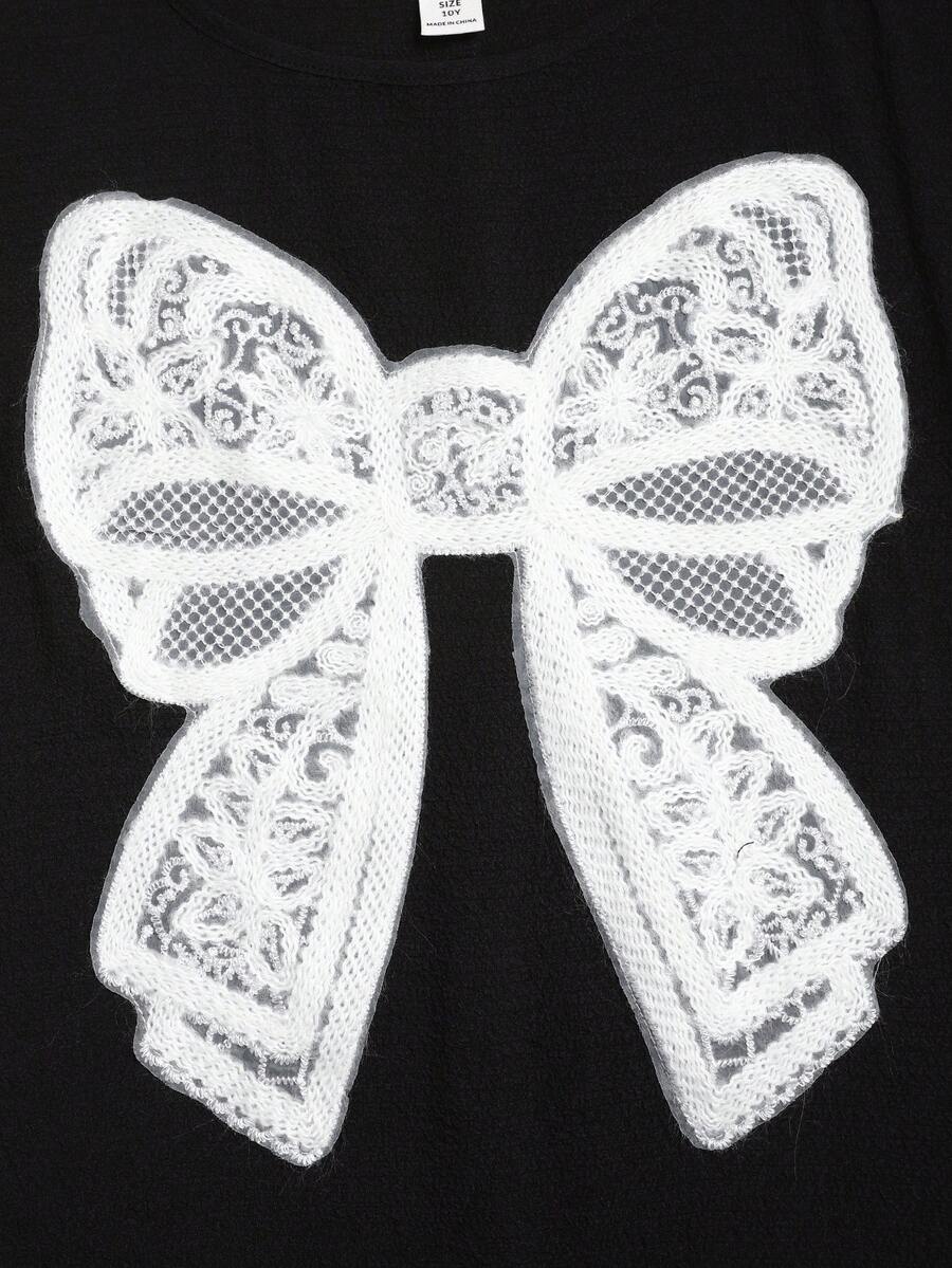 Tween girls casual black A-line long dress featuring short sleeves, a round neckline, and a decorative front bow with contrast lace trim.