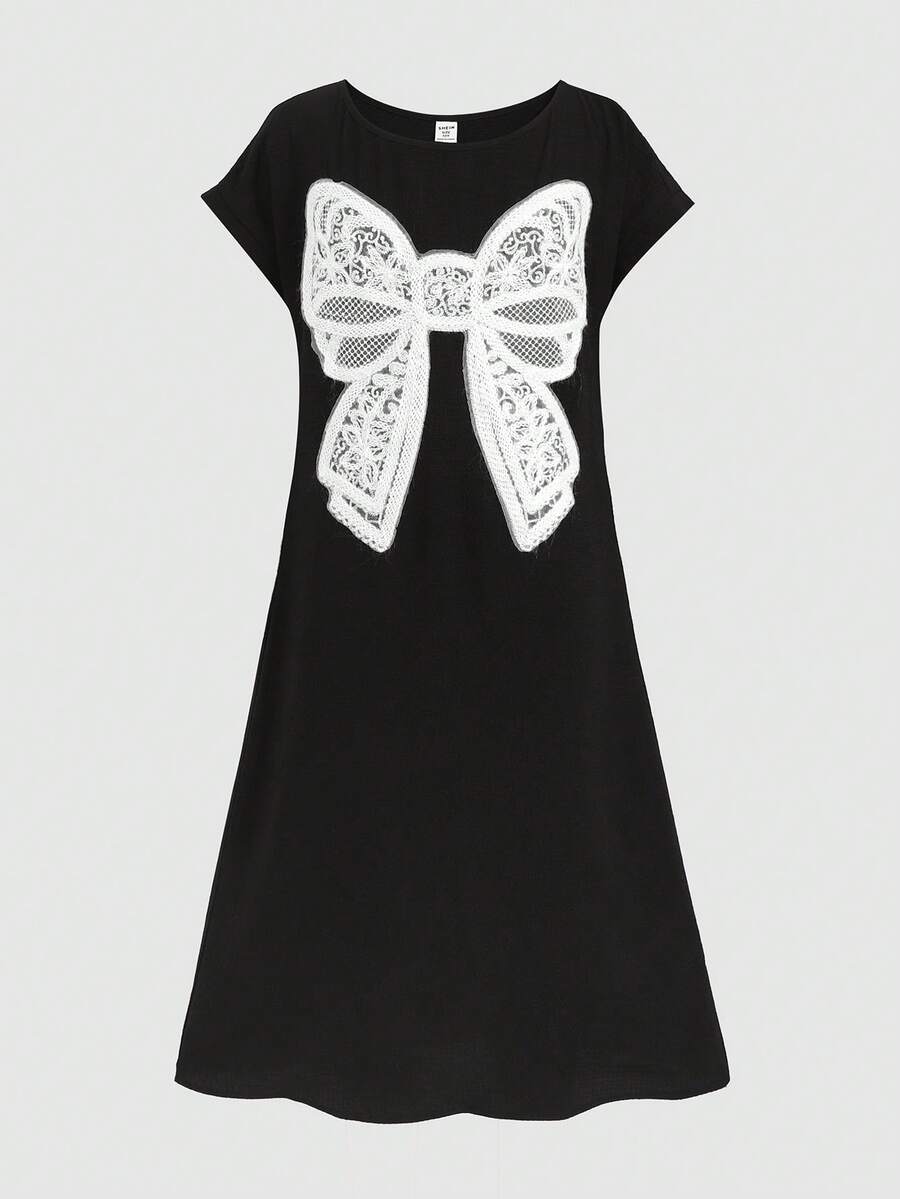 Tween girls casual black A-line long dress featuring short sleeves, a round neckline, and a decorative front bow with contrast lace trim.