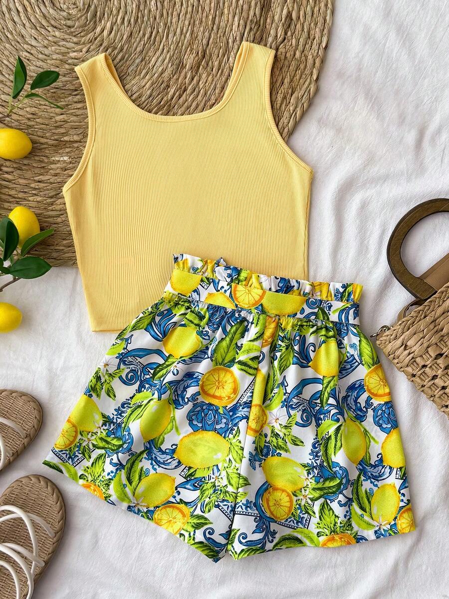 Tween girl wearing a casual 2-piece set featuring a black rib-knit scoop neck tank top and leopard print paperbag waist shorts with a matching belt.