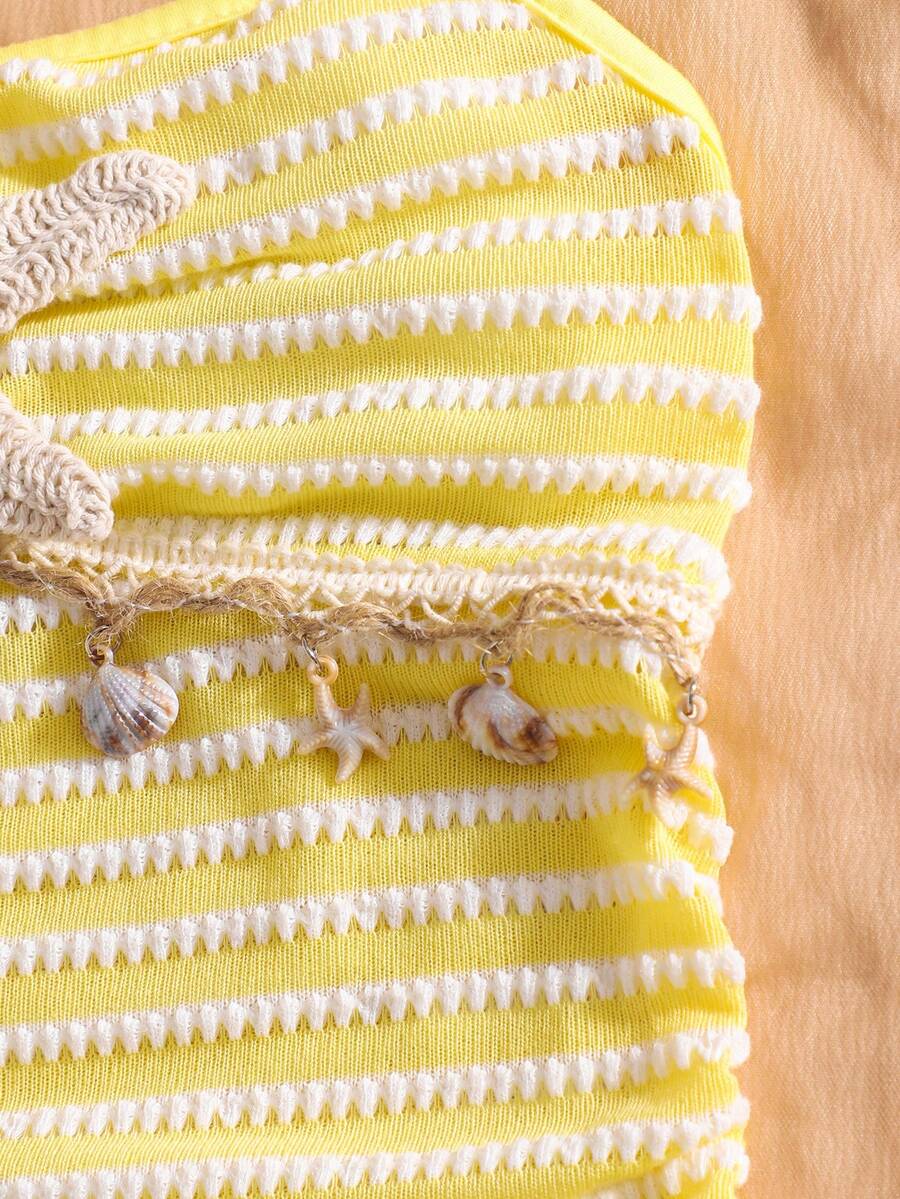 Tween girls apricot sleeveless halter mini dress with textured starfish and shell decor, shirred tiered layer, high waist, and flounce hem.