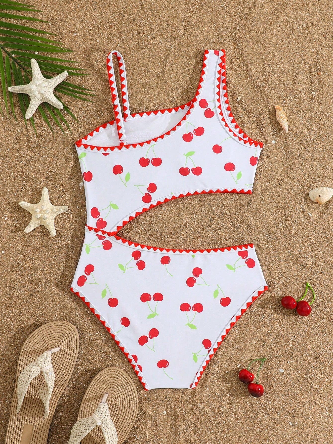 Tween girls one-piece swimsuit featuring an asymmetric neckline, pendant decor, plain design, wireless bra, high-cut bottom, and medium-stretch fabric.