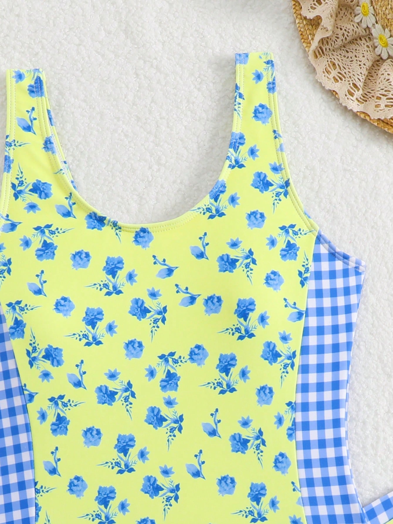 Tween girls 2-piece swimsuit set in black with full floral and plant print, featuring a sleeveless scoop-neck swim top and matching shorts-style bottoms.