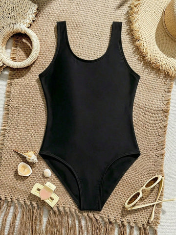 White plain camisole one-piece swimsuit for tween girls with scoop neck, fitted shape, mid-waist bottom, and wireless bra for swimming, beach, pool, or vacation wear.
