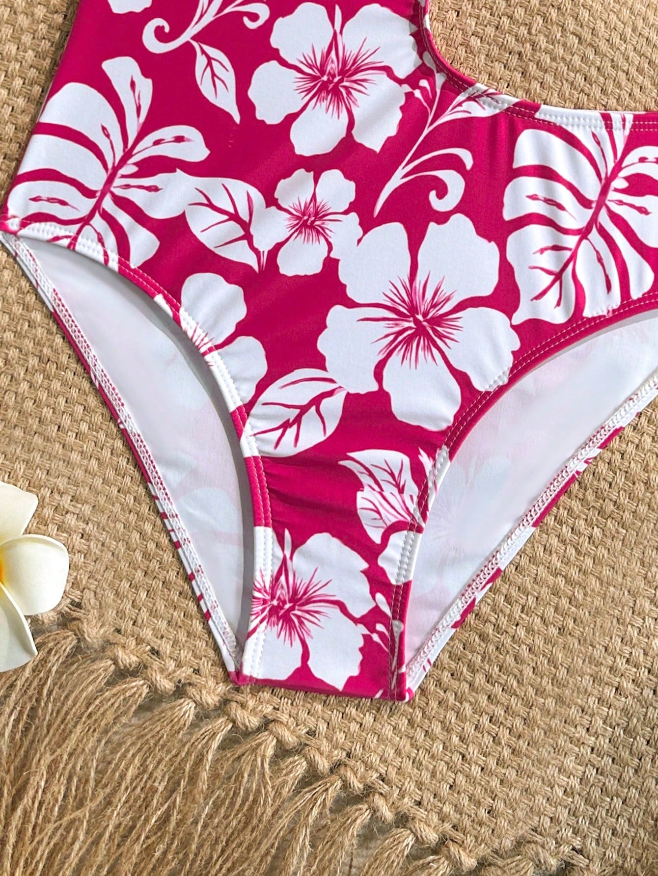 Tween girls' black and white one-piece swimsuit with striped patchwork design, scoop neck, asymmetrical cut-out detail, and fitted vacation swimwear style.