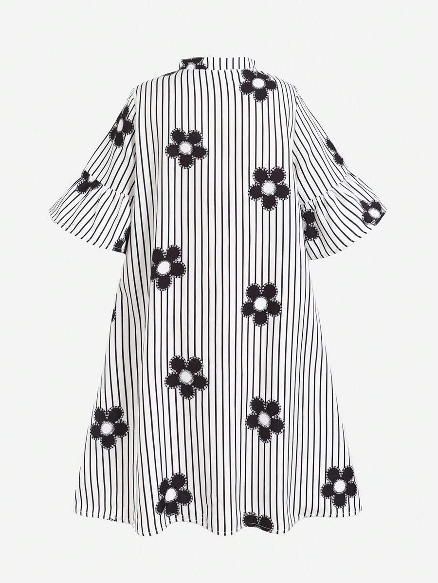 Tween girl wearing a black striped smock shirt dress with flounce half sleeves, a stand collar, and a ruffled hem.