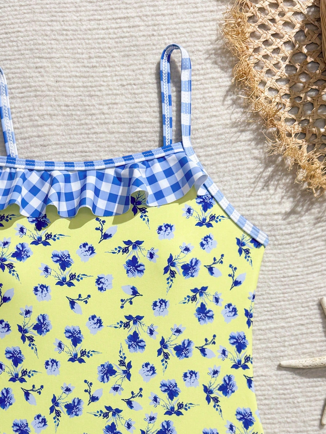 Tween girl plaid all-over print one-piece swimsuit with ruffle detail, spaghetti straps, fitted shape, and multicolor patchwork style for beach or pool wear.