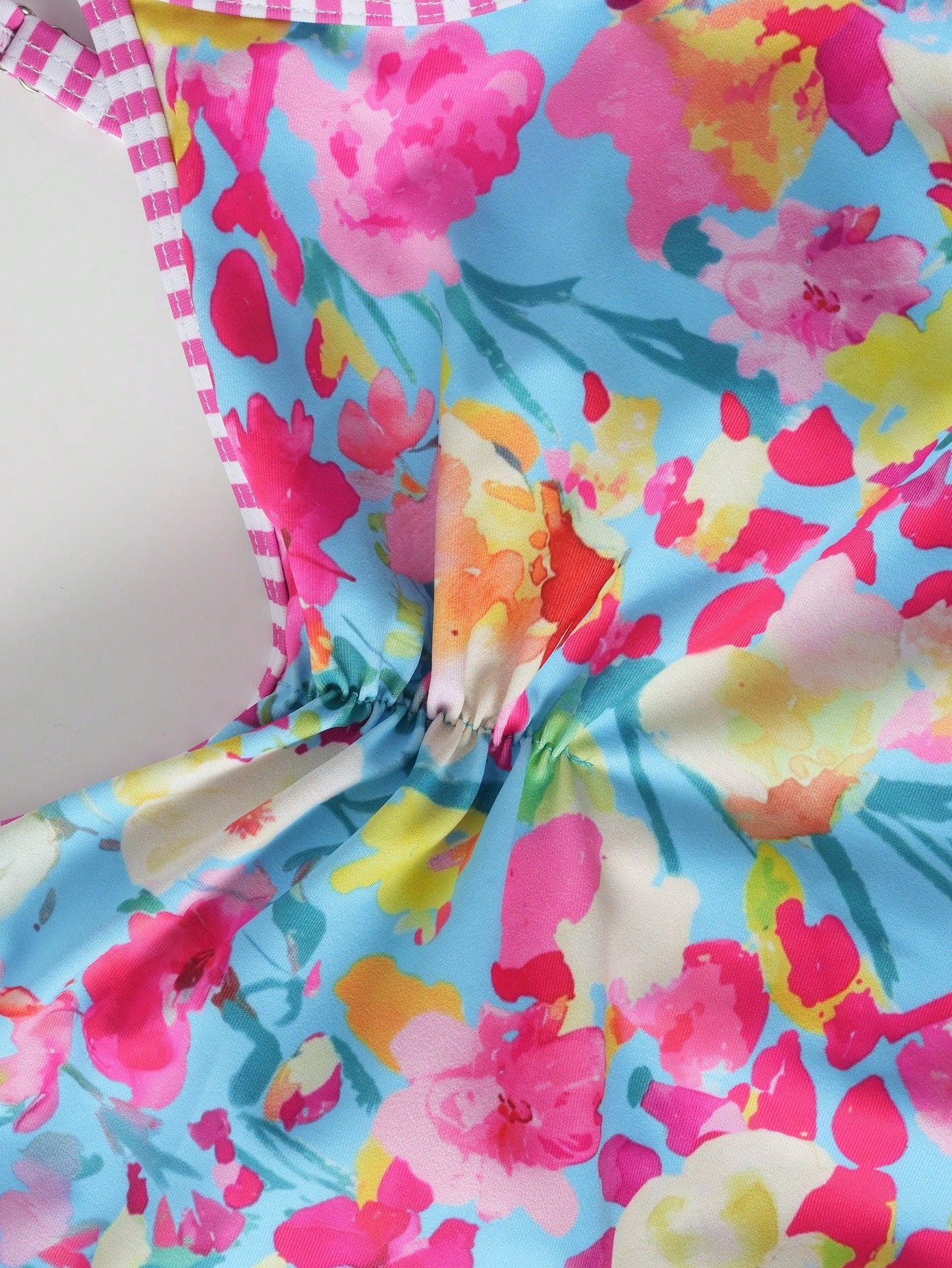 Tween girls' one-piece swimsuit featuring a ruffle splice front, ruched detailing, bow accent, contrast lace trim, and spaghetti straps.