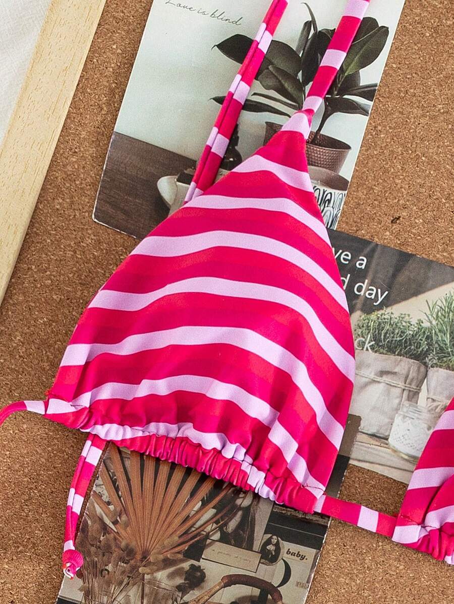 Women's printed halter neck tie two-piece swimwear featuring a wireless triangle top with removable padding and high-waist high-cut bikini bottoms.